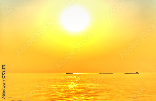 landscape,The beautiful yellow sky in the evening after sunset reflects the sea.