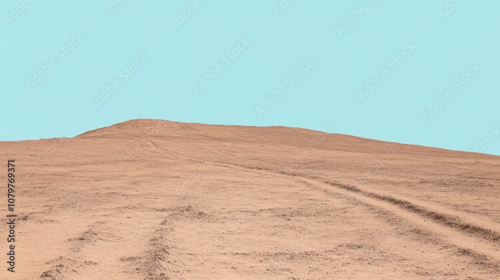 A barren landscape with tire tracks leading to a distant hill. A barren landscape with tire tracks leading to a distant hill.