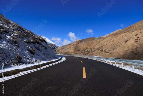 Empty road on snow mountain top photo