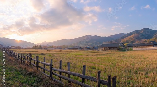 Rural Serenity: Wooden Fence, Lush Fields, Traditional Houses, Dramatic Sunset Sky in Rural China