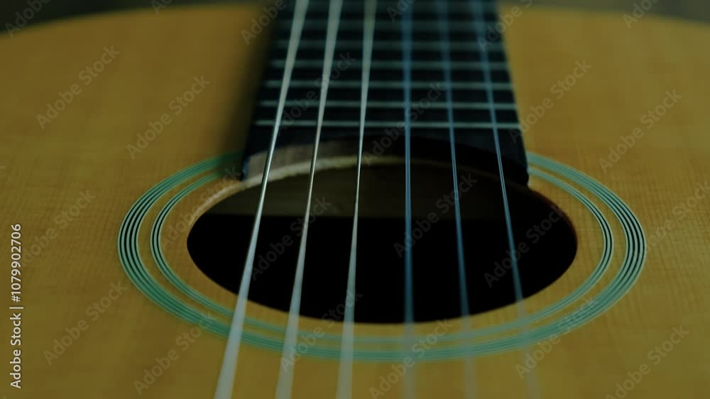 Close-up of a guitar and finger movements Close-up of a guitar and finger movements