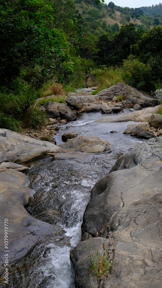 Clear River Flowing Between Rocks in a Scenic Landscape Clear River Flowing Between Rocks in a Scenic Landscape