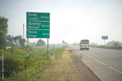 Simga Bilaspur Chilphi board., Directional signboard on highway, Indian road milestone with distances, Green distance board on roadside, Road signage showing kilometers Stock Photo. photo