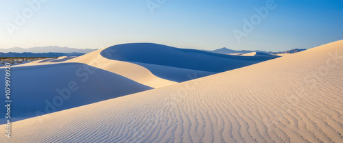 White Sands National Park, USA: Rolling white sand dunes under a bright blue sky, creating a desert scene like no other. photo