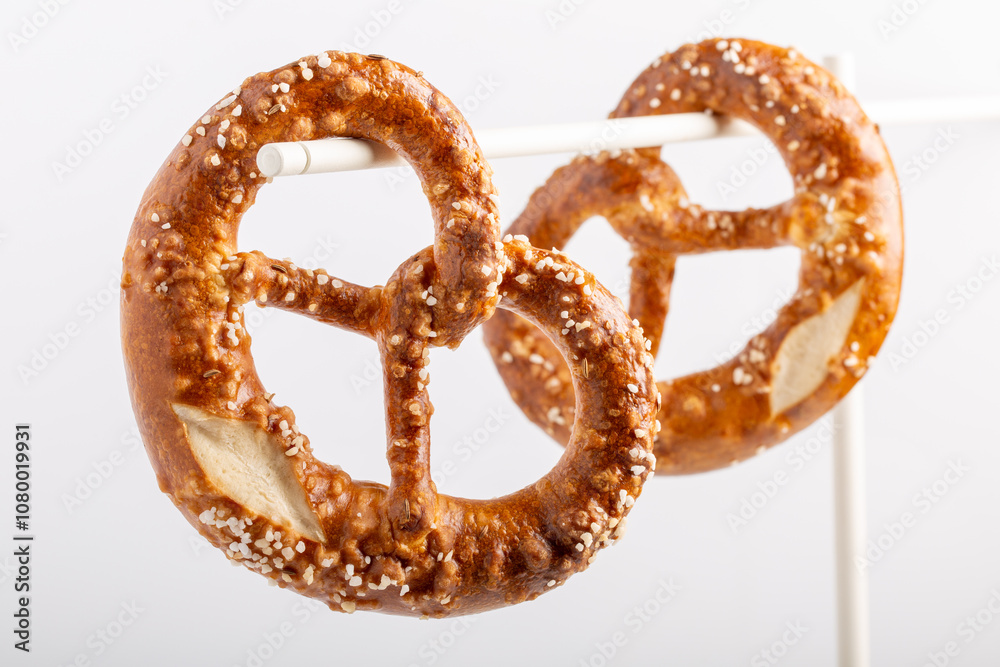 Two soft pretzel with salt on white background. Two soft pretzel with salt on white background.