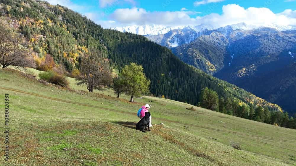 Happy moment young woman with her dog enjoying of mountain in Autumn scene with snow at Mestia Georgia, autumn forest Happy moment young woman with her dog enjoying of mountain in Autumn scene with snow at Mestia Georgia, autumn forest