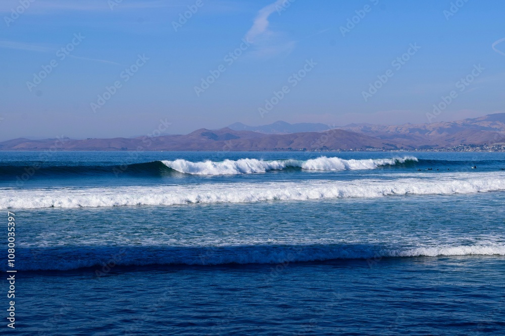 Ocean waves with mountain backdrop Ocean waves with mountain backdrop