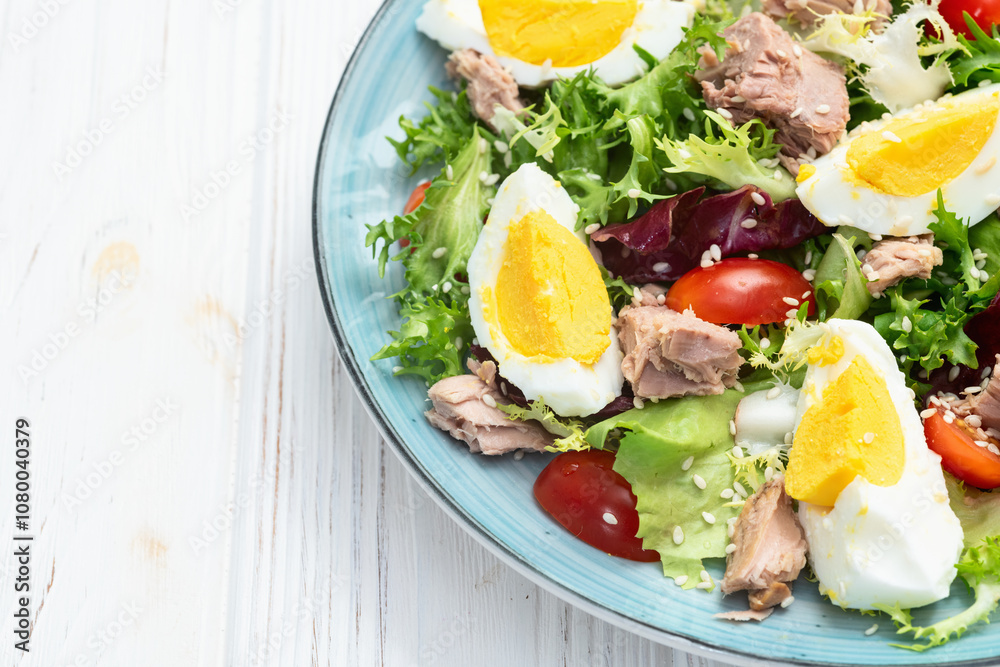 Canned Tuna salad with eggs and tomatoes photography . Top view