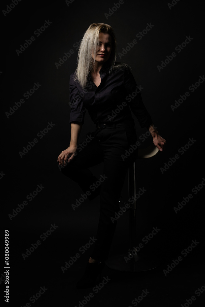 woman in black on a black background woman in black on a black background