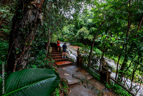 Natural background of ancient sculptures of religious tourist attractions, Naga statues, old churches by the natural waterfall from the high mountain, Wat Phalat, the way up to Doi Suthep, Chiang Mai photo