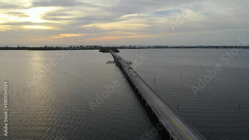 Wallpaper Mural Aerial of Anna Maria Island Bridge in Florida at sunset showcasing the bridge and the island. Crane Up Sunset W Torontodigital.ca