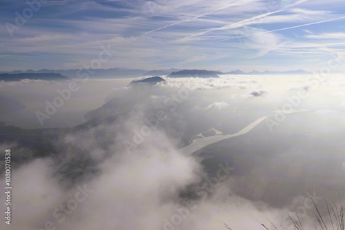 Aerial view of misty mountains and river.