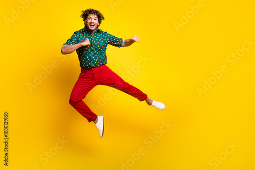 Full body portrait of nice elegant young man jump fight empty space wear shirt isolated on yellow color background