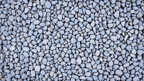 Grey ground stone rubble road background. Natural gray granite chippings, macadam, rubble or crushed stones texture, top view photo