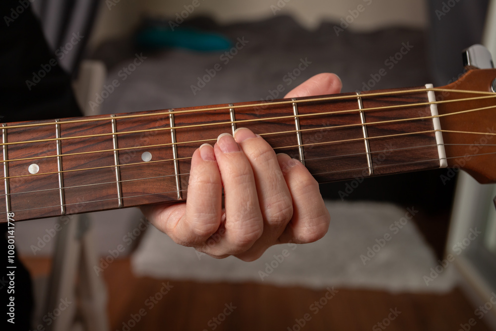 Hand Playing Acoustic Guitar Close-Up, performer strumming strings, indoor music performance