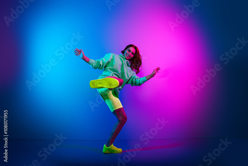 Full length photo of charming positive woman wear green sweatshirt fighting karate isolated neon blue color background