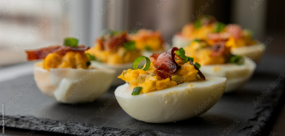 deviled eggs topped with crispy bacon and green onion, creating a savory and colorful appetizer. Perfect for party starters, gatherings, or holiday platters deviled eggs topped with crispy bacon and green onion, creating a savory and colorful appetizer. Perfect for party starters, gatherings, or holiday platters