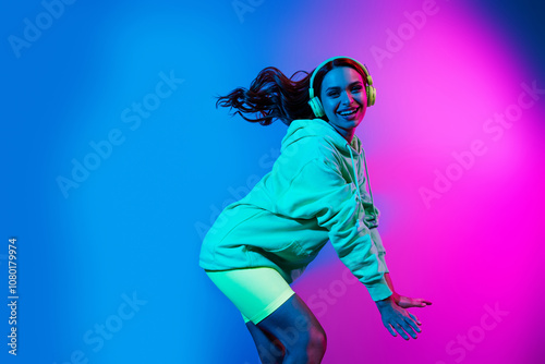 Photo of funky lovely girl wear green hoodie headphones having fun empty space isolated pink light color background photo