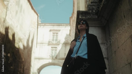 Beautiful young business woman waiting outside on street in old European city