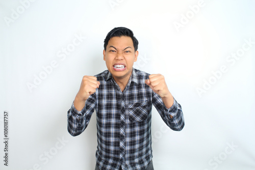 angry asian man raising hand show furious expression isolated on white wear plaid shirt photo