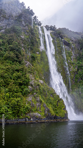 Waterfall, mountains, Milford Sound, New Zealand photo