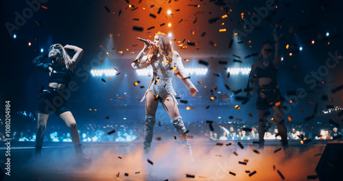 Portrait of Two Beautiful Female Pop Singers Performing on Stage. Action Camera Switching From One Performer to Another. Choreography and Stunning Visuals Make for Creative Atmosphere