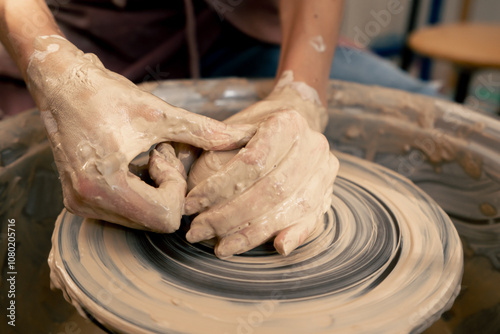 close up the clay modeling studio young girl hands giving shape to clay on a potter's wheel applied art clayware old craftsmanship teacher helps