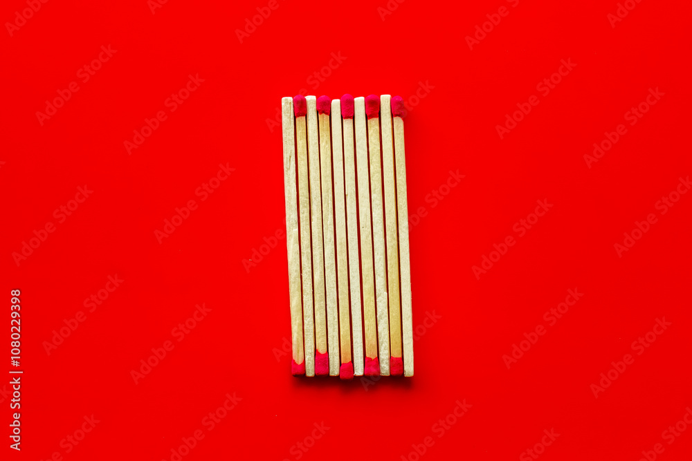 Matches for danger concept on red background top view