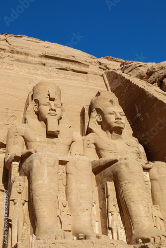 close view of giant sandstone statues in Abu Simbel temple, Egypt