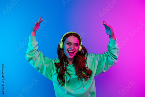 Photo of adorable lovely girl wear green hoodie headphones having fun empty space isolated pink light color background photo