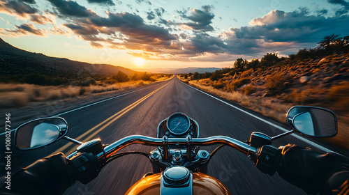 A Harley-Davidson motorcycle cruising down Route 66 at dusk with the open road ahead.
