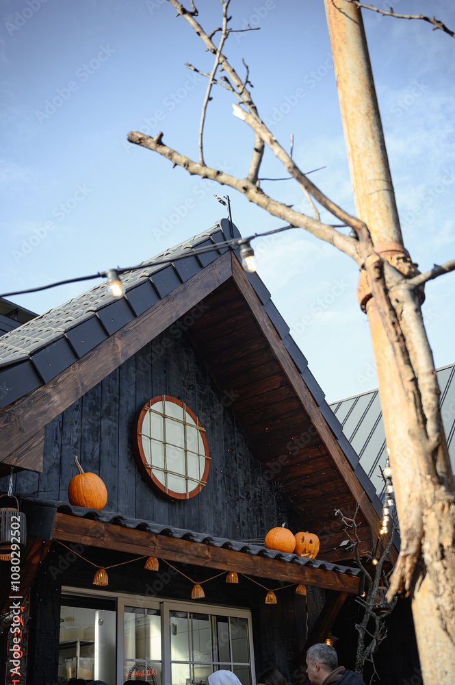 pumpkins in autumn on the roof of the house. Dark house pumpkins in autumn on the roof of the house. Dark house