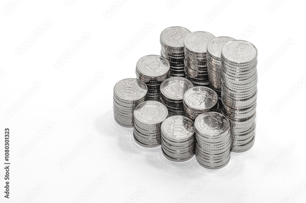 Detail of columns of silver coins isolated on white. Business and finance idea. Copy space. Detail of columns of silver coins isolated on white. Business and finance idea. Copy space.
