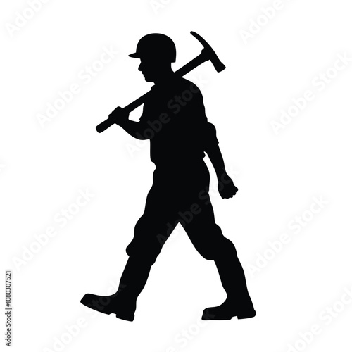 A man is holding a pickaxe and walking on a rock. He is wearing a helmet