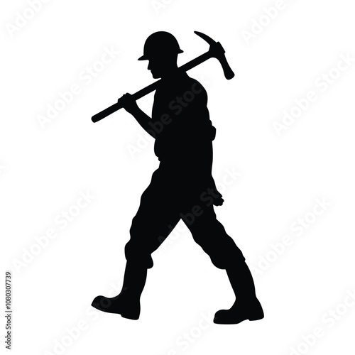 A man is holding a pickaxe and walking on a rock. He is wearing a helmet