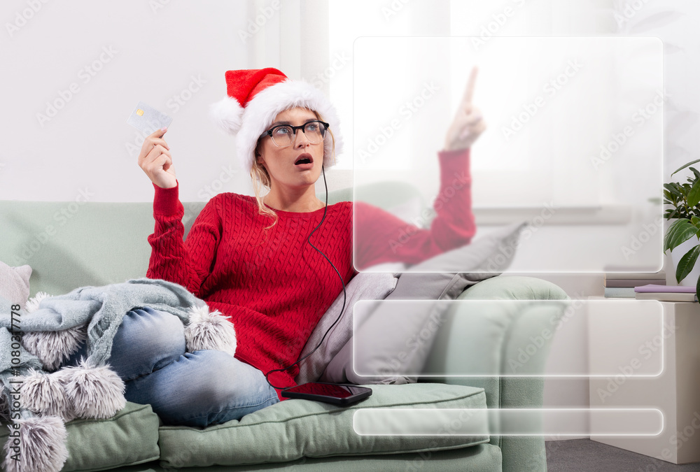 A woman sits comfortably on her couch at home, using her smart glasses to browse the internet for Christmas shopping, while using her credit card to make purchases and payments through her smartphone A woman sits comfortably on her couch at home, using her smart glasses to browse the internet for Christmas shopping, while using her credit card to make purchases and payments through her smartphone