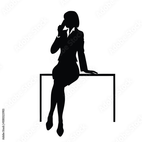 A woman is sitting on a desk and talking on her cell phone. She is wearing a suit and heels