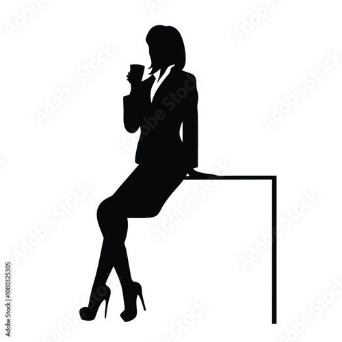 A woman is sitting at a desk with a laptop. She is talking on the phone