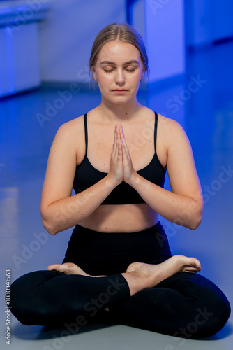 close up in the spiritual development studio master class in yoga middle-aged girl in a black top and pants in bright room pose asana strength exercises handstand only