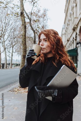 Canvas Print French redhead business woman with a cup of coffee walking in an urban city in E