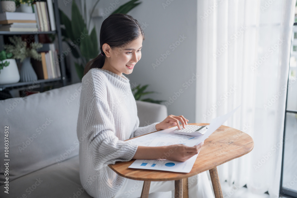 Businesswoman Accountant analyzing investment charts Invoice and pressing calculator buttons over documents. Accounting at home Businesswoman Accountant analyzing investment charts Invoice and pressing calculator buttons over documents. Accounting at home