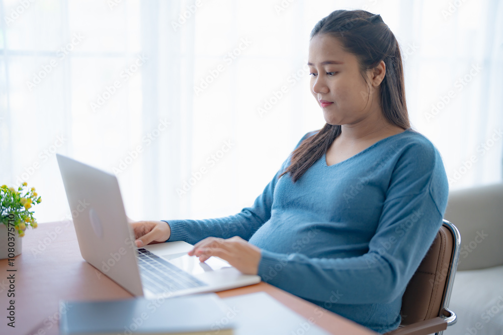 Pregnant asian woman using laptop at home pregnant businesswoman typing on laptop working on remote project in home office pregnancy concept Pregnant asian woman using laptop at home pregnant businesswoman typing on laptop working on remote project in home office pregnancy concept
