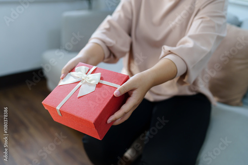 Happy woman hugging gift box. Receiving Valentine present. Cheerful girl with Xmas present or open box xmas new year birthday gift