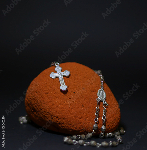 Rosary on a stone and black aground