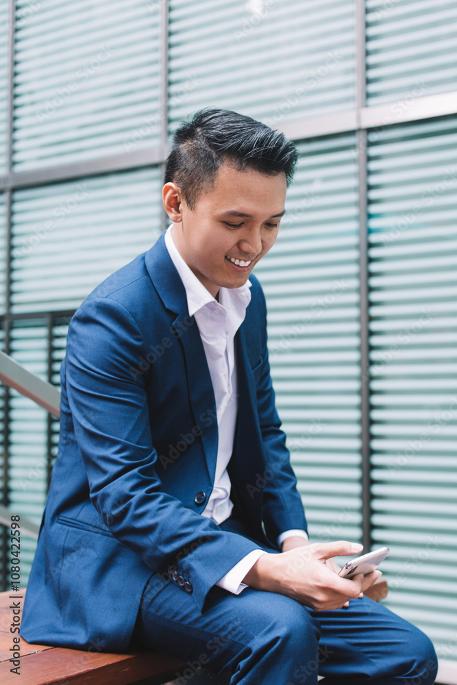 Asian entrepreneur in suit smiling and chatting Asian entrepreneur in suit smiling and chatting