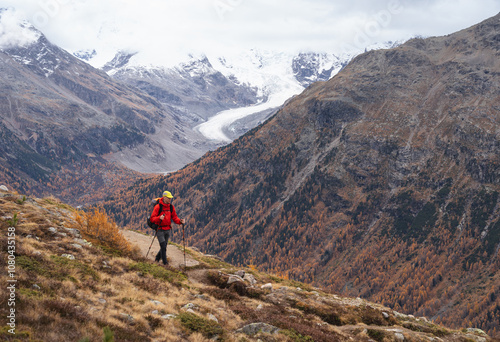 A man hiking in the mountains above Pontresina, in autumn.