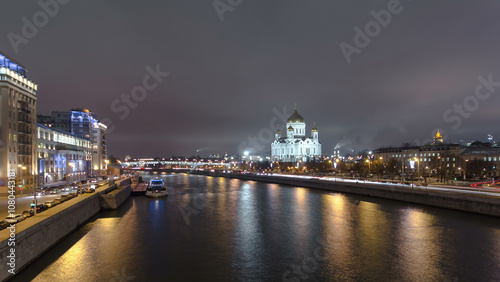Majestic orthodox Cathedral of Christ Saviour illuminated at dusk on bank of Moscow river. Timelapse hyperlapse, Russia