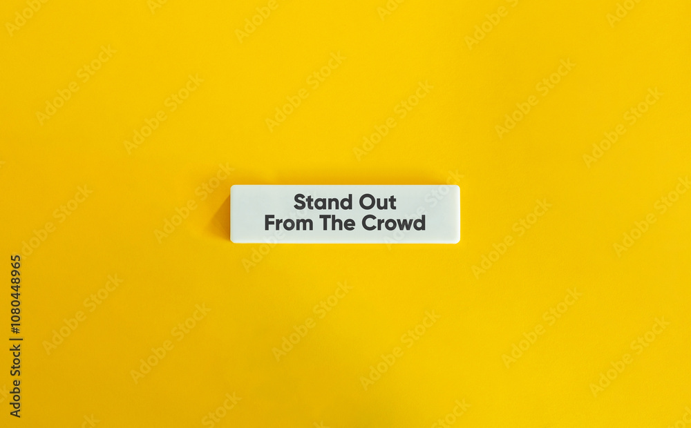 Stand Out From The Crowd. Text on Block Letter Tile on Yellow Background. Minimal Aesthetic. Stand Out From The Crowd. Text on Block Letter Tile on Yellow Background. Minimal Aesthetic.