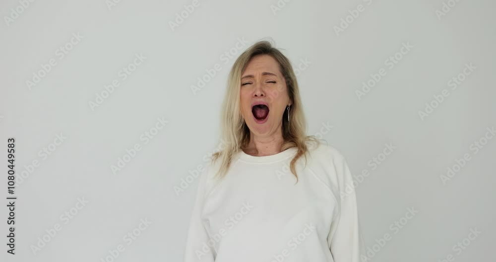 Beautiful woman yawns on a white background