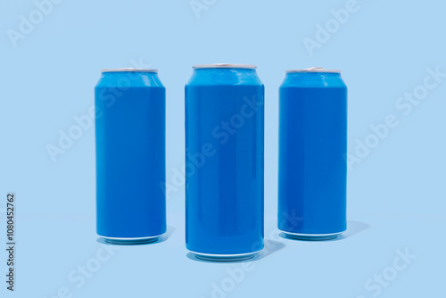 Three blue aluminum cans on blue background